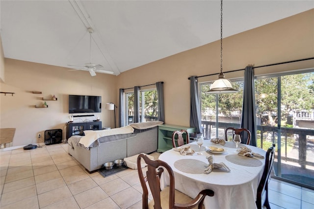 tiled dining room featuring high vaulted ceiling and ceiling fan