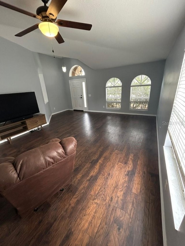 living room featuring ceiling fan and dark wood-type flooring