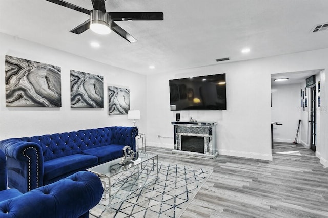 living room featuring hardwood / wood-style flooring and ceiling fan