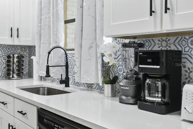 kitchen featuring white cabinets, decorative backsplash, dishwasher, and sink