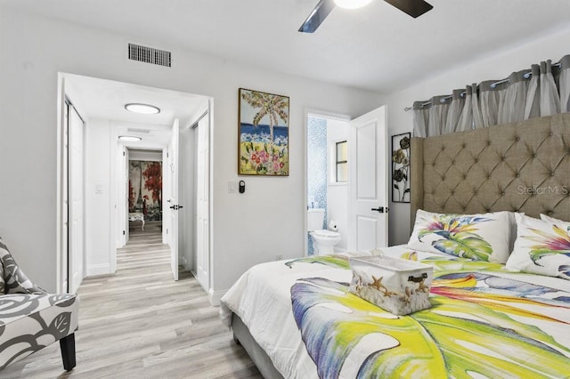 bedroom featuring ceiling fan, ensuite bathroom, and light hardwood / wood-style flooring