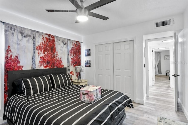 bedroom featuring light wood-type flooring, a closet, and ceiling fan