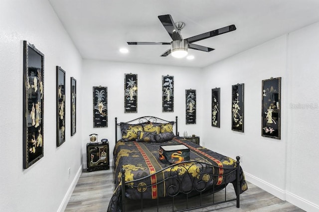 bedroom with wood-type flooring and ceiling fan