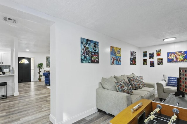 living room featuring a textured ceiling and hardwood / wood-style flooring