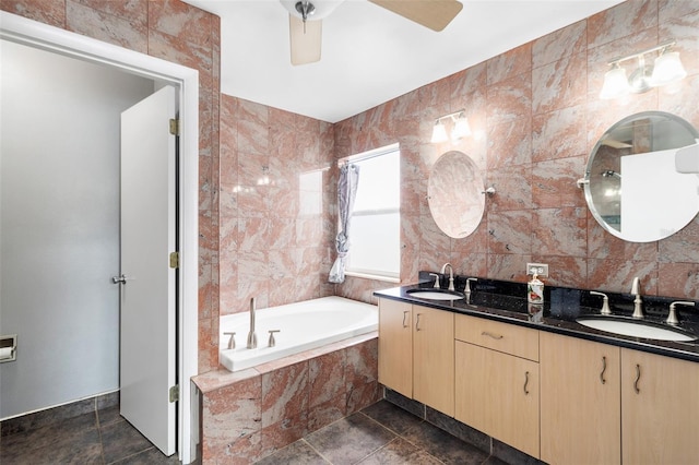 1600 Gray Bark Dr, Oldsmar, FL 34677 - bathroom with a sink, tile walls, double vanity, and a relaxing tiled tub