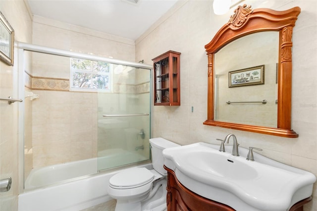 1600 Gray Bark Dr, Oldsmar, FL 34677 - full bath featuring combined bath / shower with glass door, tile walls, vanity, and toilet