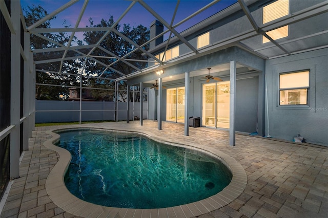 1600 Gray Bark Dr, Oldsmar, FL 34677 - pool at dusk featuring a fenced in pool, glass enclosure, ceiling fan, and a patio area