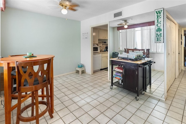 kitchen with backsplash, ceiling fan, light tile patterned floors, and white appliances