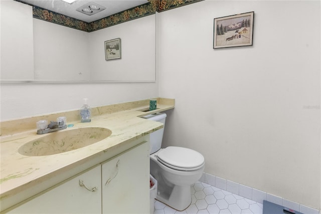 bathroom featuring tile patterned floors, vanity, and toilet