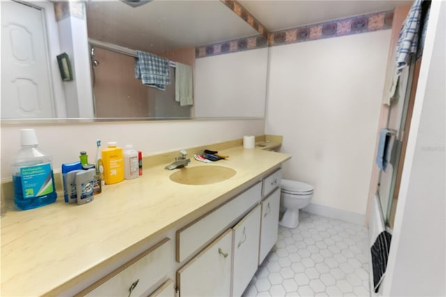 bathroom featuring tile patterned floors, vanity, toilet, and an enclosed shower