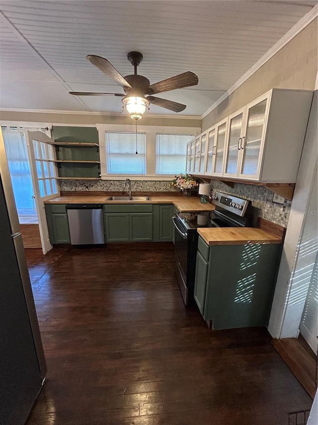 kitchen with wood counters, green cabinets, sink, appliances with stainless steel finishes, and dark hardwood / wood-style flooring