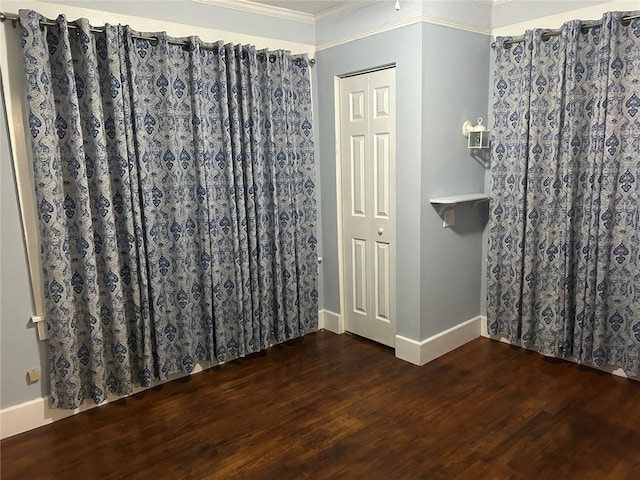 interior space with hardwood / wood-style flooring and crown molding