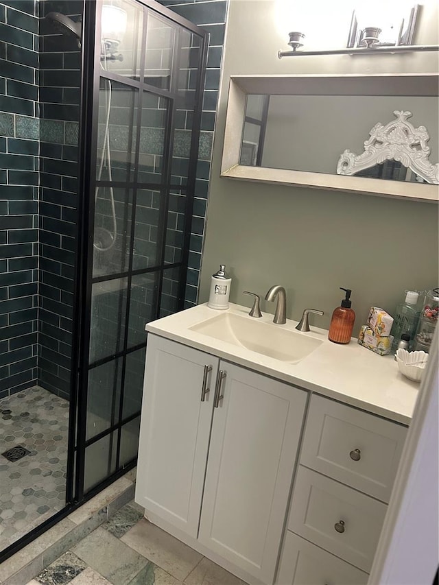 bathroom featuring vanity and tiled shower