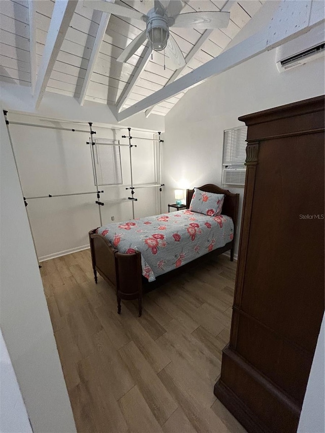 bedroom with hardwood / wood-style floors, lofted ceiling with beams, ceiling fan, and wood ceiling