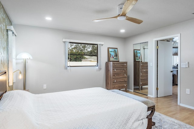 bedroom featuring a closet, light hardwood / wood-style flooring, and ceiling fan