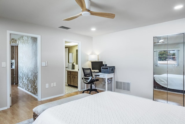 bedroom featuring ceiling fan, light wood-type flooring, and ensuite bathroom