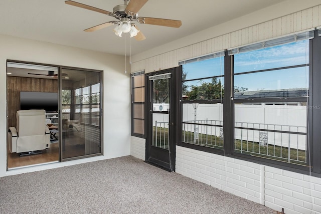 carpeted spare room with a wealth of natural light and ceiling fan