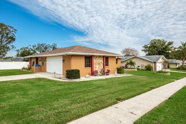 ranch-style house featuring stucco siding, driveway, fence, a front yard, and an attached garage