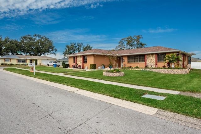 single story home featuring a front yard