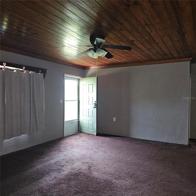 carpeted empty room with ceiling fan, ornamental molding, and wood ceiling