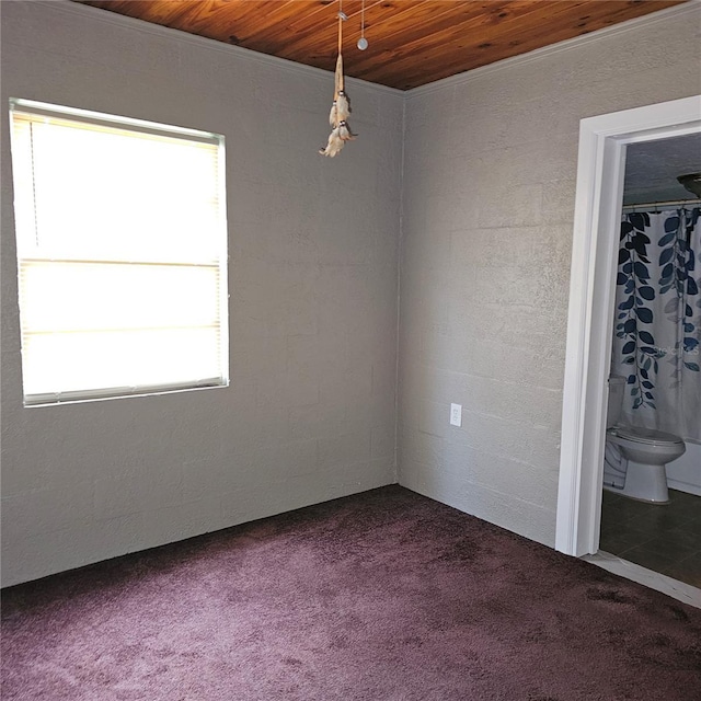 carpeted spare room with wooden ceiling