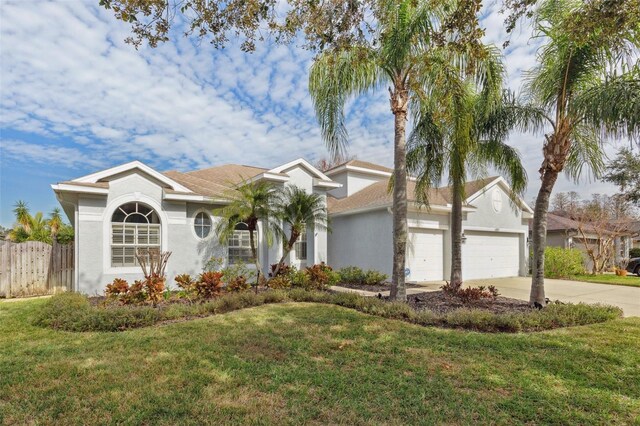 view of front of home with a garage and a front yard