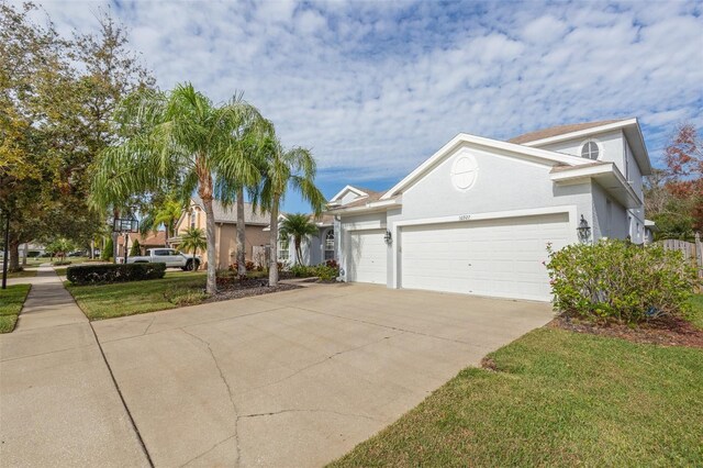 view of front of property with a front yard and a garage