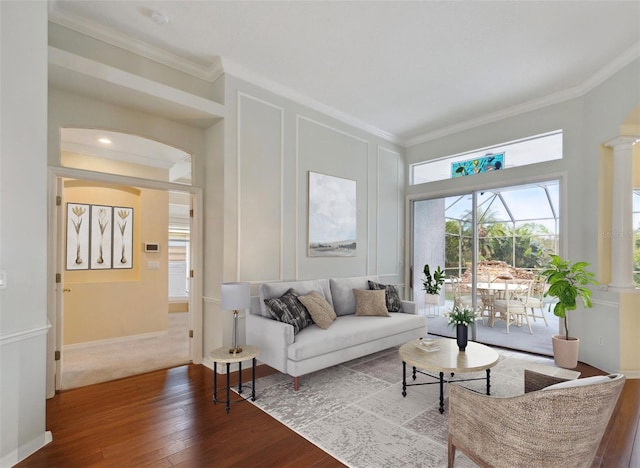 living room with hardwood / wood-style floors and crown molding