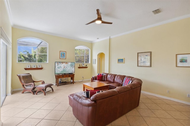 tiled living room featuring ceiling fan and crown molding