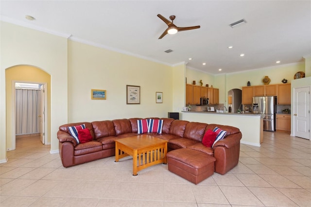 living room featuring ceiling fan, light tile patterned flooring, and crown molding