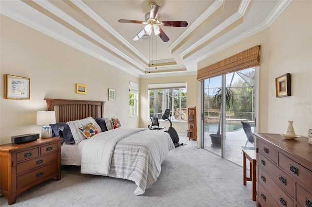 carpeted bedroom featuring a tray ceiling, ceiling fan, ornamental molding, and access to outside