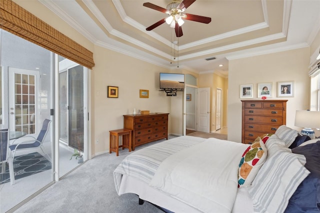 bedroom with access to outside, multiple windows, ceiling fan, and a tray ceiling