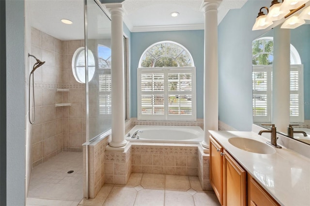 bathroom with tile patterned flooring, vanity, independent shower and bath, and a healthy amount of sunlight