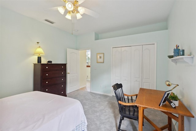 bedroom featuring ceiling fan, light colored carpet, and a closet