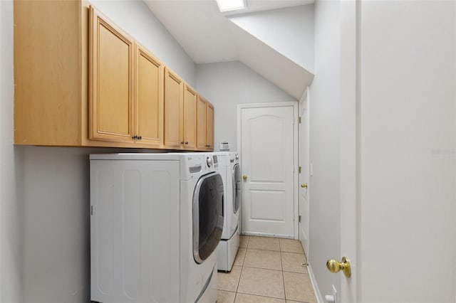 laundry area with cabinets, washing machine and dryer, and light tile patterned flooring