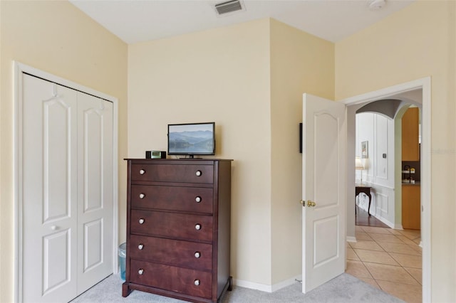 bedroom with a closet and light tile patterned flooring