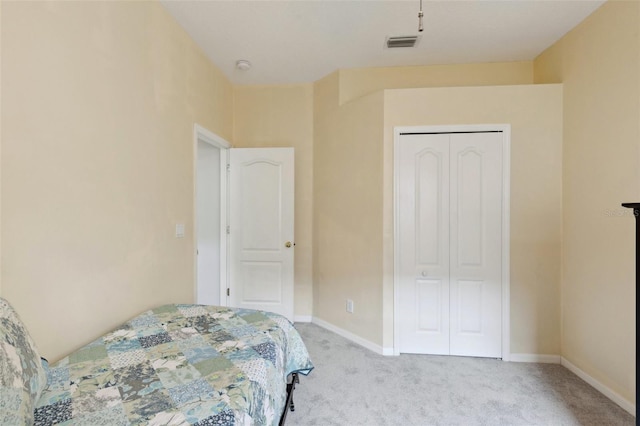 bedroom featuring a closet and light colored carpet