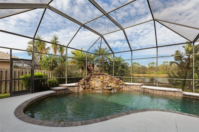 view of swimming pool featuring pool water feature, a lanai, and a water view