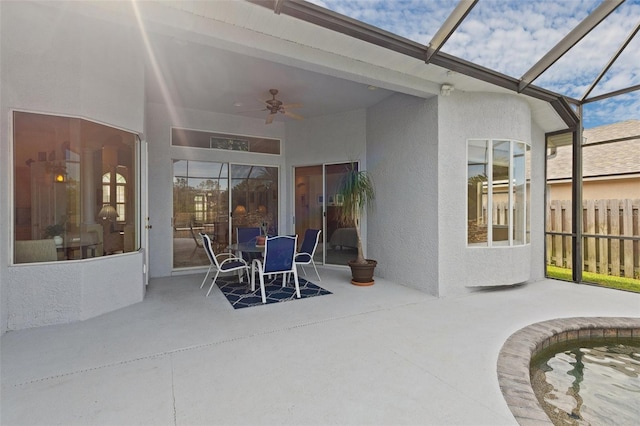 view of patio / terrace with glass enclosure and ceiling fan