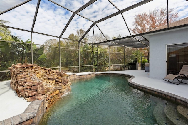 view of swimming pool featuring a patio, pool water feature, and glass enclosure