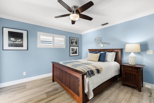 bedroom featuring ornamental molding, light hardwood / wood-style floors, and ceiling fan