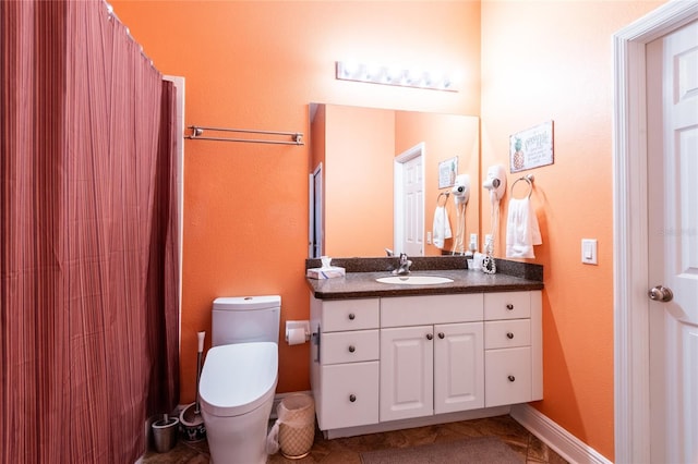 bathroom featuring tile patterned floors, vanity, and toilet