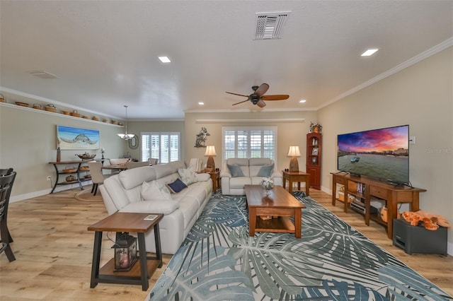 living room with ceiling fan, ornamental molding, and light hardwood / wood-style flooring