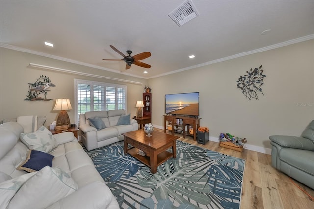 living room with ceiling fan, wood-type flooring, and ornamental molding