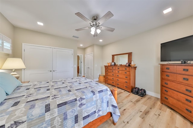 bedroom with ceiling fan, a closet, and light hardwood / wood-style flooring