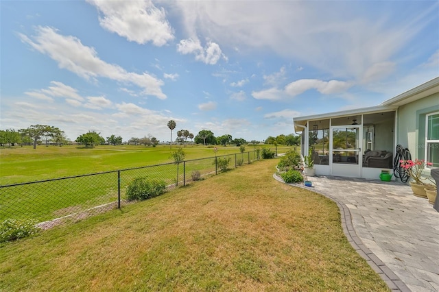 view of yard featuring a sunroom and a patio