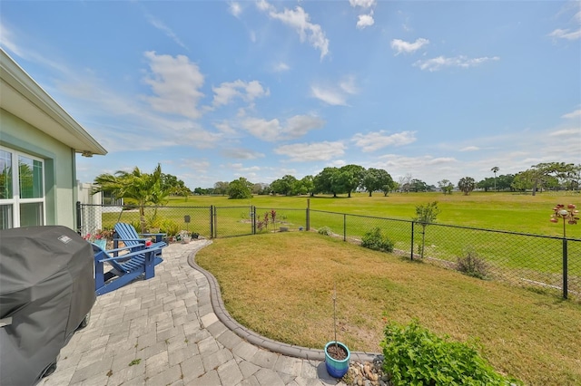 view of yard with a rural view and a patio