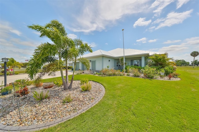 view of front of property featuring driveway, a front lawn, and stucco siding