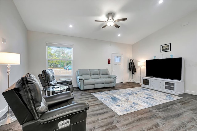 living room with hardwood / wood-style flooring, ceiling fan, and vaulted ceiling