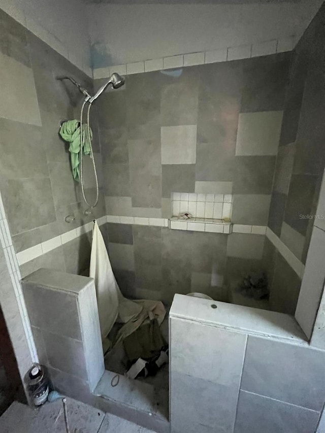 bathroom with tiled shower